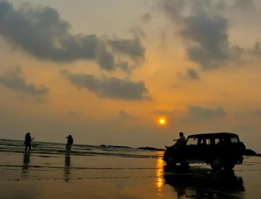 Vehicles driving on Muzhappilangad Drive-in Beach, Kannur